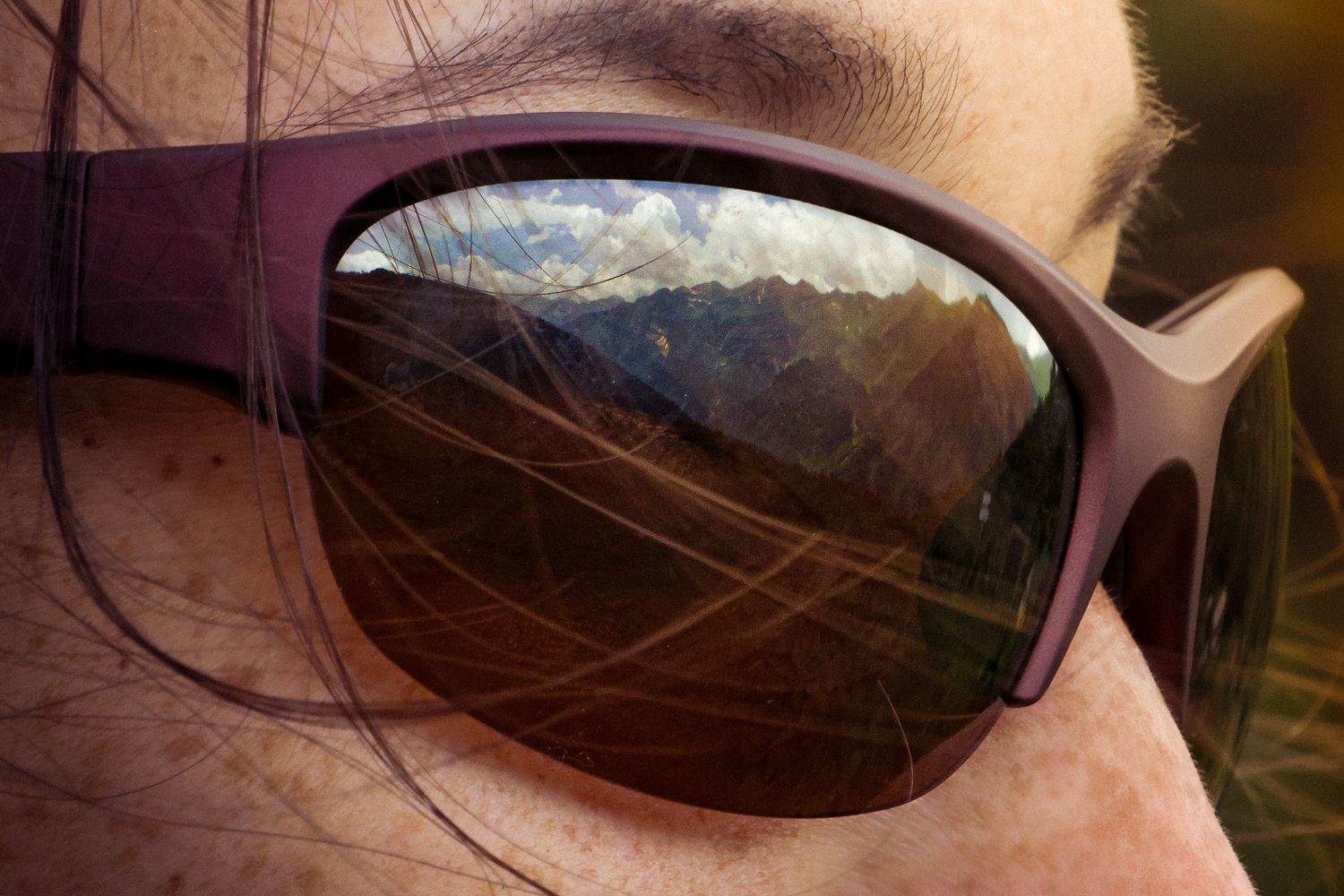 Mountains reflected in a hiker’s sunglasses