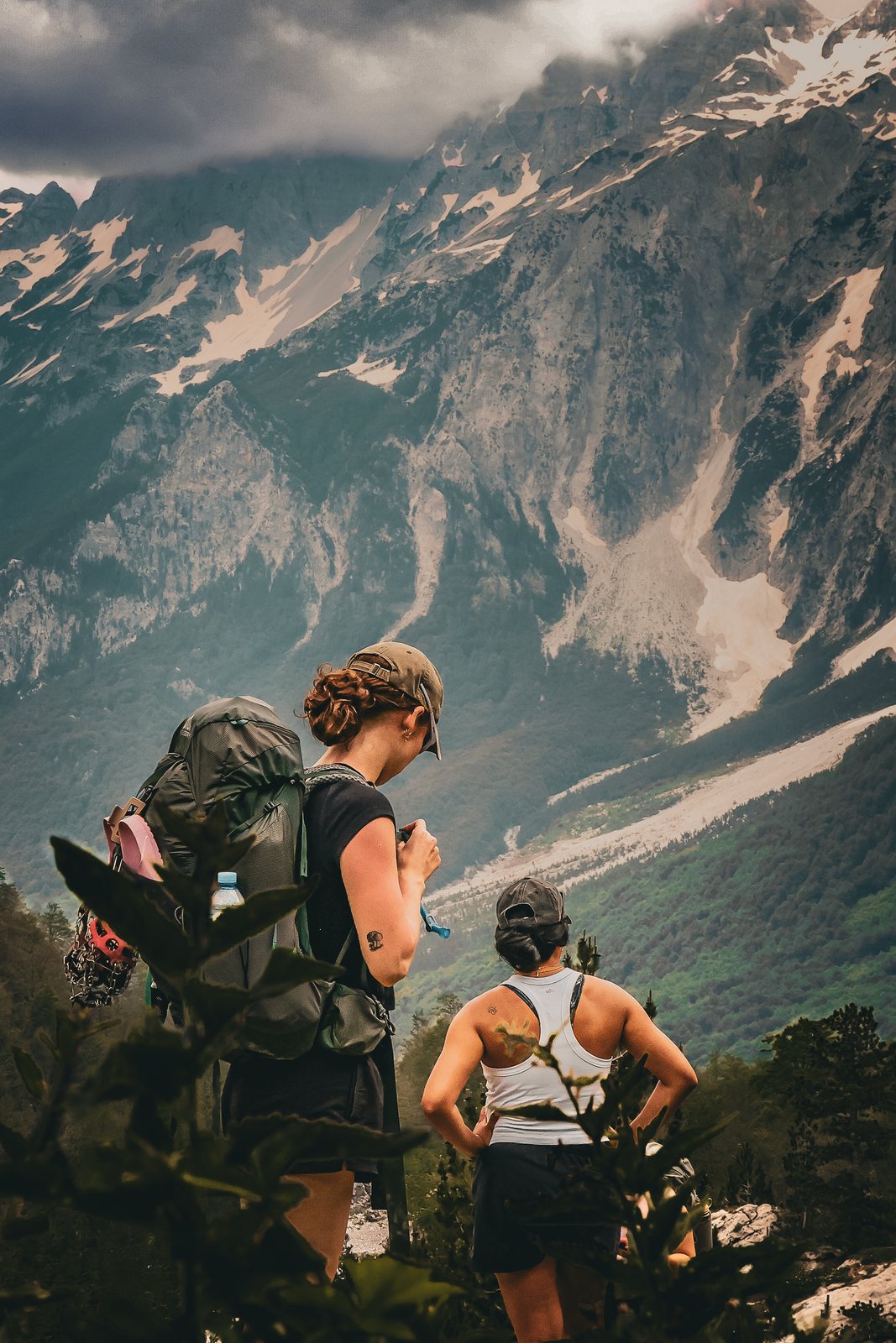 Two hikers look into a deep valley