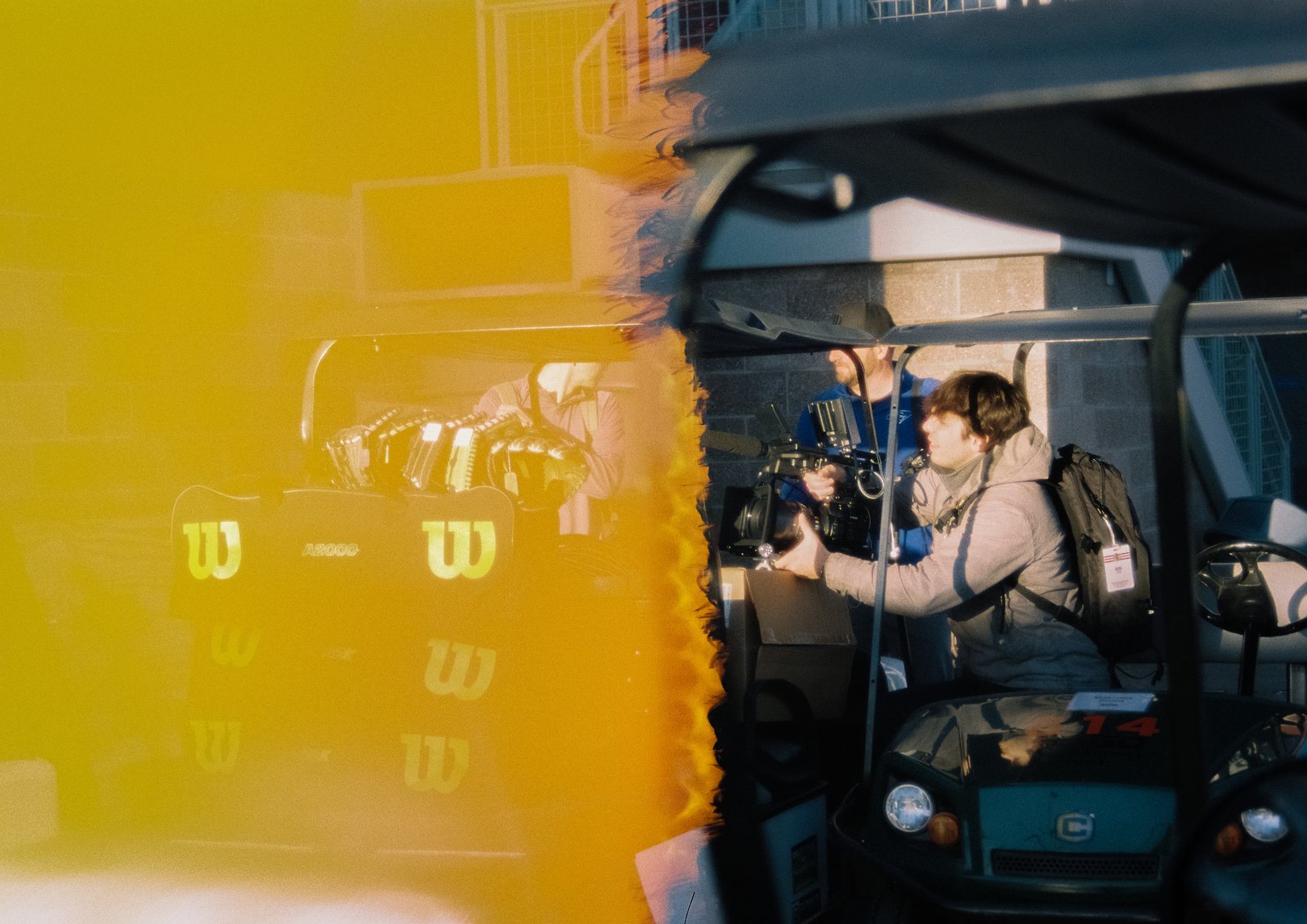 A camera crew at work through an amber light leak