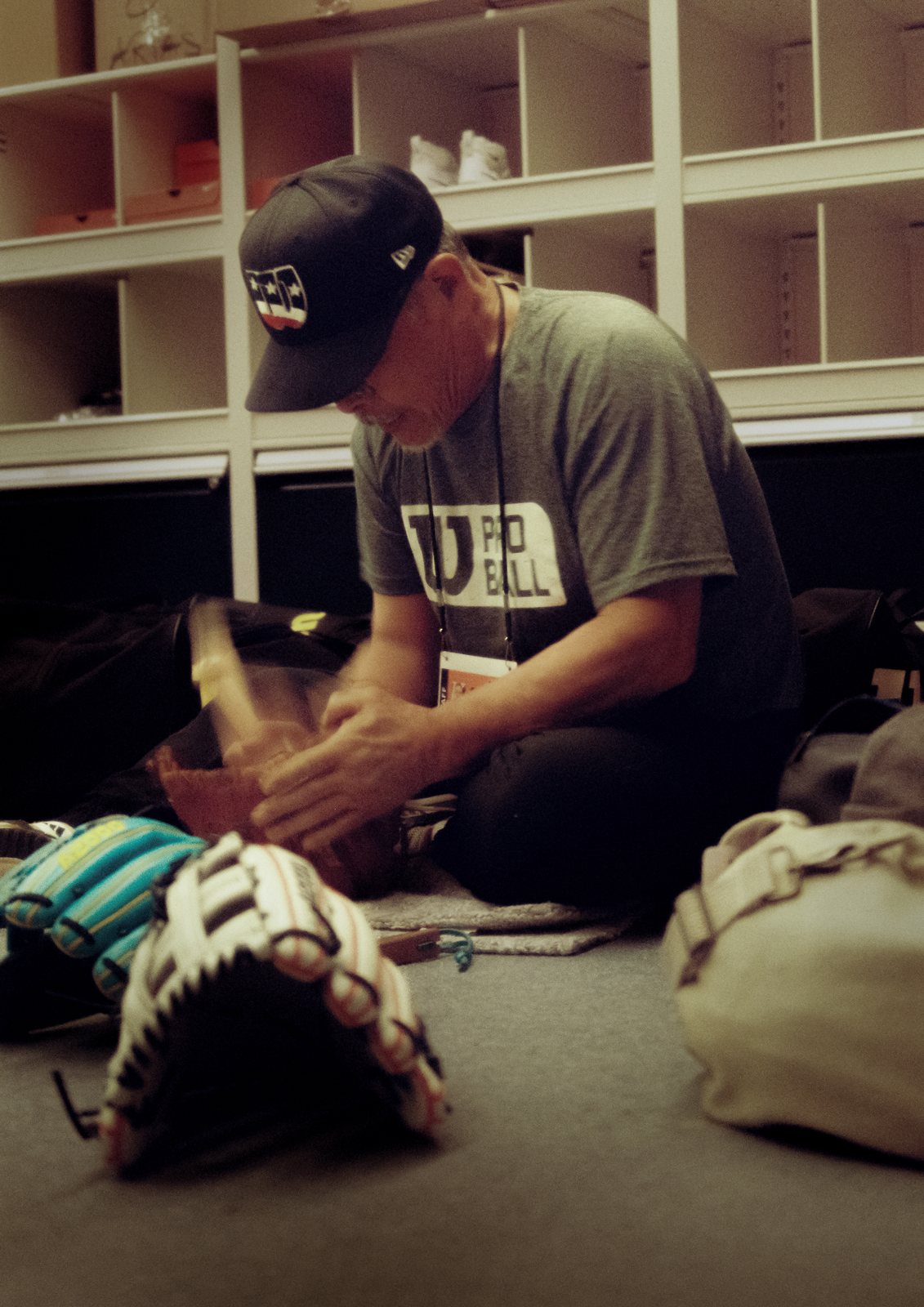 A craftsman shapes a glove on the floor