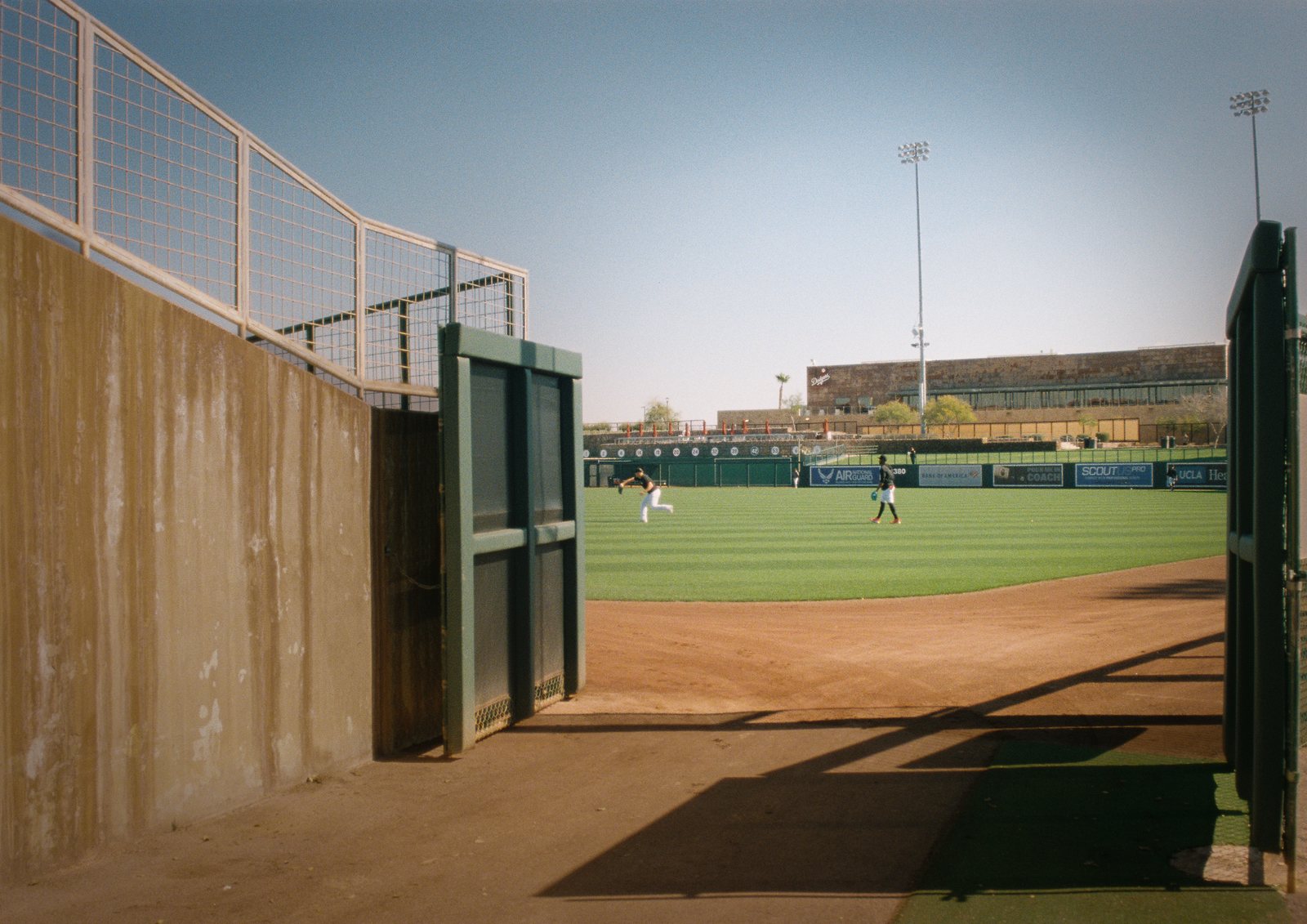 A tunnel opening onto a sunny ballfield