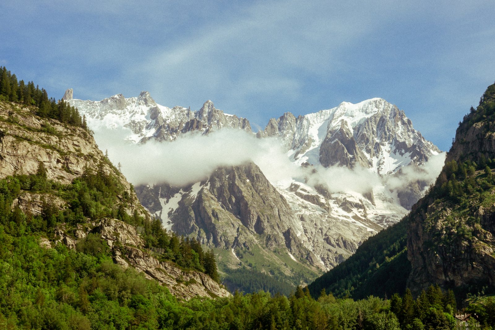 Snowy peaks framed by rock walls