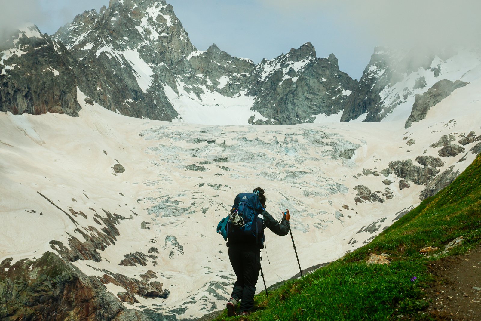 A hiker crossing a glacier