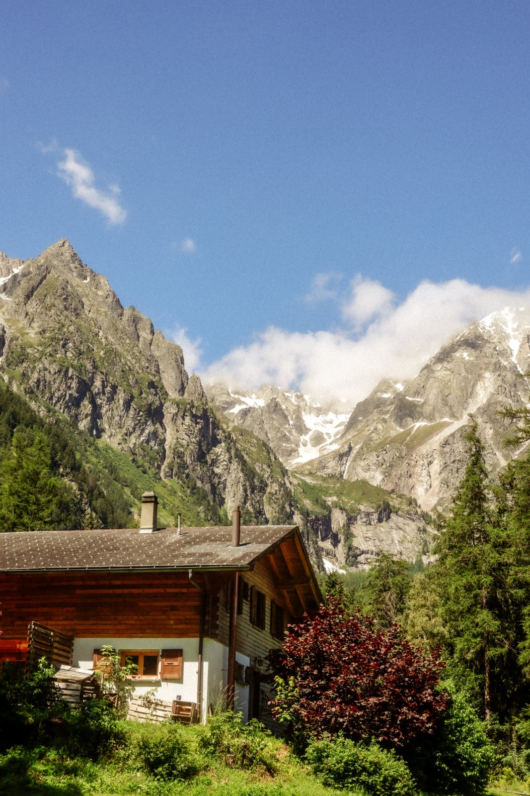 A wooden chalet below jagged peaks